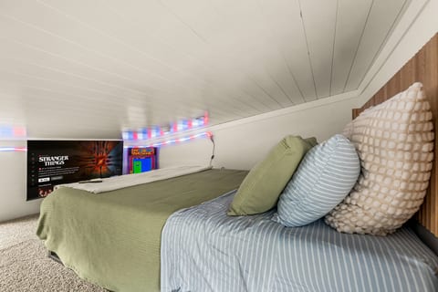 Settle into the loft bed, flip on the neon lights, and challenge whoever's up there to a round of Ms. Pac-Man before lights-out.