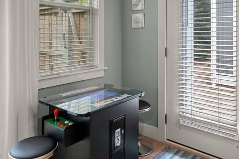 Fun arcade nook with natural light and casual seating