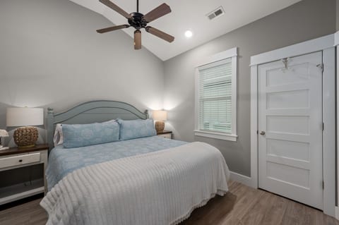 Bright, cozy bedroom with vaulted ceilings and soothing coastal decor
