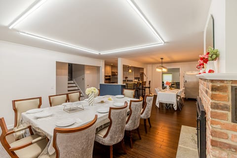 Spacious dining area with fireplace, breakfast bar, and stylish lighting