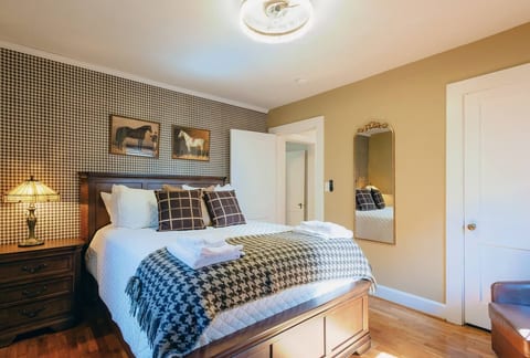 Charming Bedroom: Enjoy a blend of modern comfort and equestrian vibes in this bedroom with stylish fan light fixture