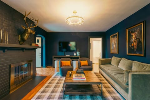 Living Room Retreat: Dive into stylish decor with a sleek fireplace and Frankie the Stag with all of his charm!