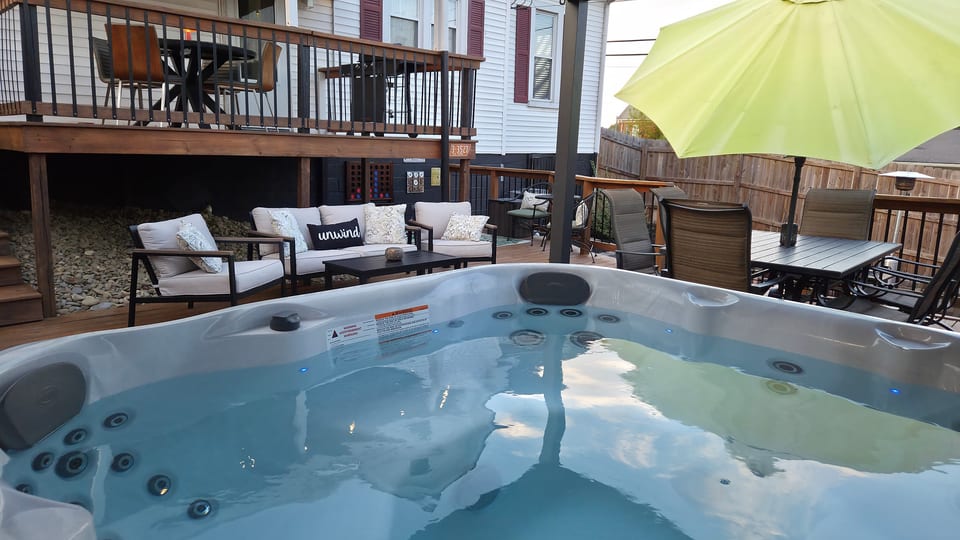 Private hot tub patio with cozy lounge seating and outdoor dining