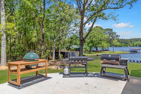 Lakefront patio with trio of grills and smoker—ideal for cookouts