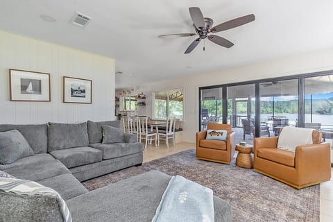 Open-concept lounge with lake views and seamless patio access