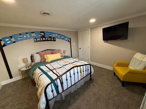 The Sun Studio/Beale St Room! It's fun and vibrant! Wardrobe with shelves and a hanging rack for clothes. This room also has a 42" Smart TV.