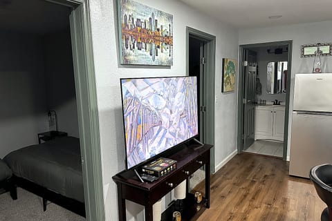 Smart, comfy layout with TV, private bath access, and full-size fridge