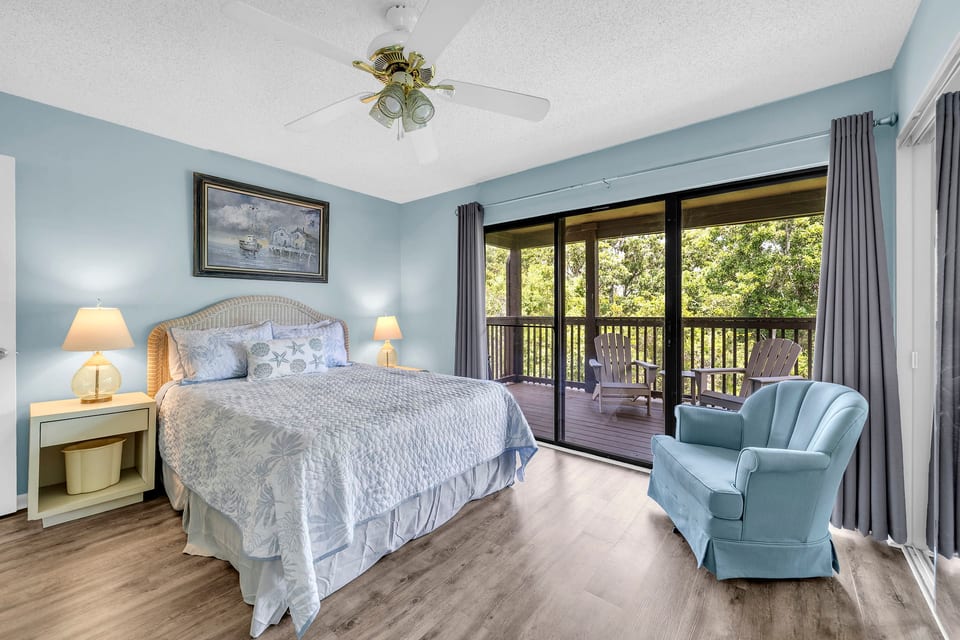 Welcome to Coral Cove! Wake up to peaceful treetop views from the spacious primary bedroom, featuring a queen bed, a Smart TV, plenty of closet space, and direct access to your private covered balcony.