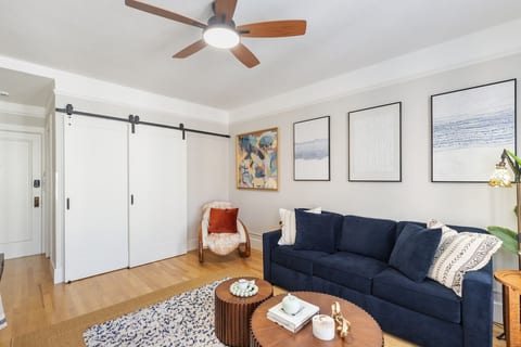Murphy bed folded away behind barn doors adding extra living space