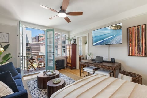 Full size writing desk, 55” wall mounted TV, High Speed Internet, nesting tables and queen size pull out sofa bed w/memory foam mattress. French doors to private balcony.