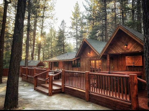 Our spacious back deck overlooks our recreation area, game room & enclosed private grounds.