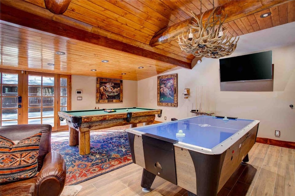 Large game room with 3 smart TV’s, two arcade, games, gaming console, and Commercial Air Hockey & pool tables for those competitive family tournaments!