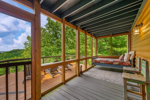 The screened back porch has a swing bed with a twin mattress - perfect for afternoon naps.
