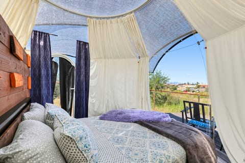Open the curtains and enjoy the inviting queen bed inside your dome retreat