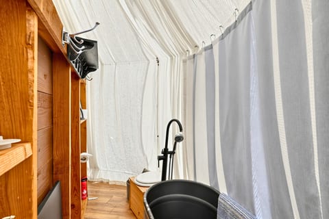 Enjoy the convenience of a private bathroom with a bathtub and composting toilet