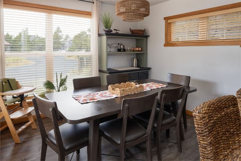 Dining room with enough seating for all between the dining table and the bar.