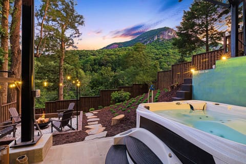 Serene outdoor area featuring Hot Tub, Fire Pit and Bar area with breathtaking views of Chimney Rock!