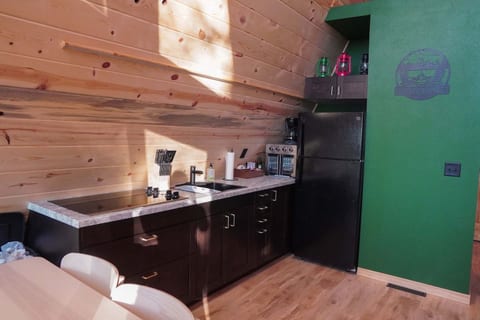 Cozy cabin-style kitchenette with dining nook and rustic modern charm