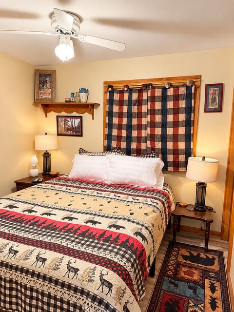 Cozy rustic bedroom with lodge decor, warm lighting, and cabin charm