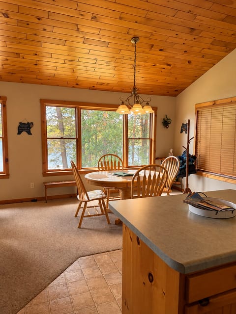 Bright dining nook with lake views, warm wood accents, and natural light
