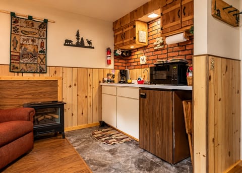 Cozy rustic kitchenette with fireplace warmth and cabin charm