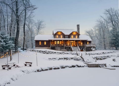Back of Cabin during winter. It's a perfect sledding hill for the kids right onto the frozen pond!