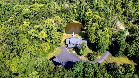 Aerial view of our property. Plenty of parking, privacy and space for the kids to run, play and explore.  The treehouse is hidden by the trees, but is just off to the upper right of the pond.