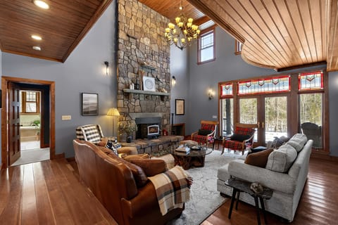 Great Room with soaring chimney and wood burning stove; plenty of seating for your entire group!