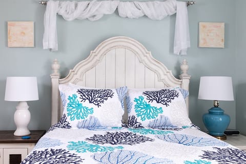 Settle into a comfortable queen bed dressed in hotel-quality linens and soft pillows at the end of the day. The room offers generous storage for clothing and personal items, with a closet, shelving, and bedside storage that make it easy to unpack, stay org