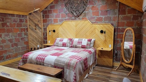 Upstairs is a large bedroom, complete with a king bed and a 65 inch Roku TV.