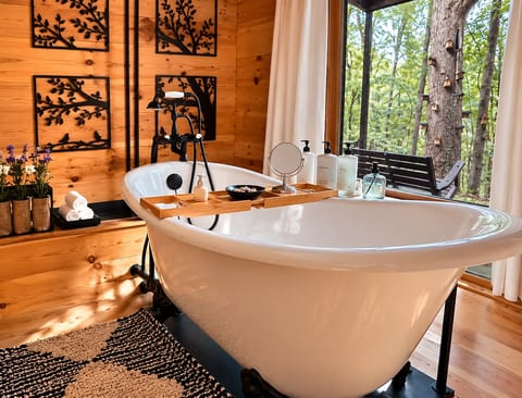 Secluded spa-like soaking tub on the lower level with peaceful forest views ✨