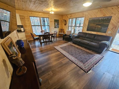 Living Room featuring native wood accents, 6 seat pub table, and private view of the surrounding woods.