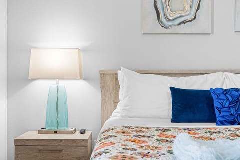 Master king with its own bath for one couple. Room-darkening shades help everyone sleep in after a late show.