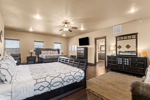 Two king beds and a 55″ TV in one room. Room for two couples, or a parent and older kids, with nobody on the couch.