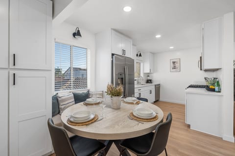 Dining area located right next to the kitchen. Kitchen comes fully stocked with dishes, cutlery, knives, glasses, wine glasses, pots and pans, toaster, blender and Nespresso coffee machine.