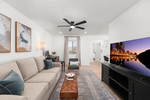 Living room with queen sofa bed and 55" Smart TV.