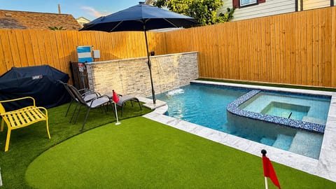 Your private backyard retreat with heated pool, hot tub, putting green, lounge seating and gas grill.