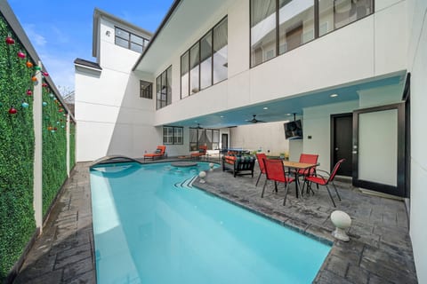 Step into your private outdoor oasis w/a heated pool featuring a built-in table & stools. Relax on the covered patio w/a TV, outdoor dining, ping pong, cornhole, and lounge chairs—perfect for soaking up the sun and enjoying endless entertainment