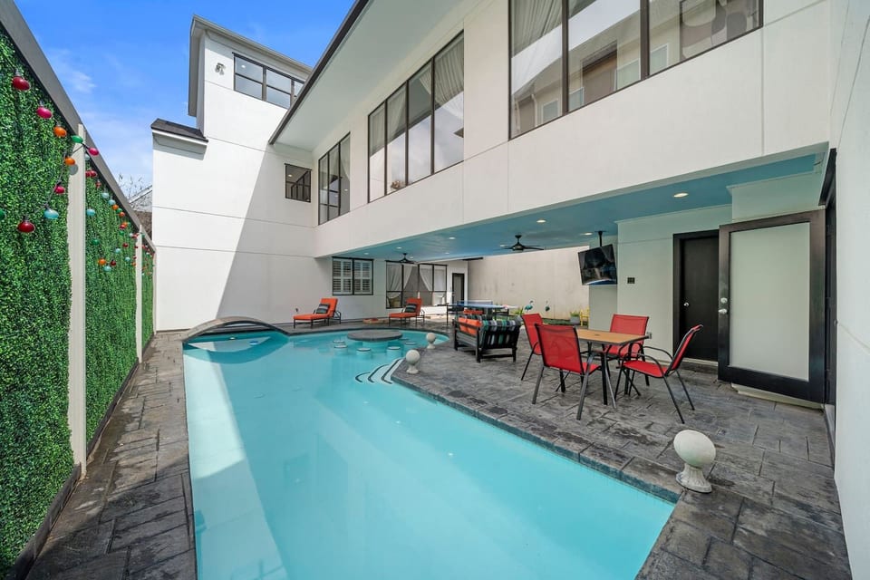 Step into your private outdoor oasis w/a heated pool featuring a built-in table & stools. Relax on the covered patio w/a TV, outdoor dining, ping pong, cornhole, and lounge chairs—perfect for soaking up the sun and enjoying endless entertainment
