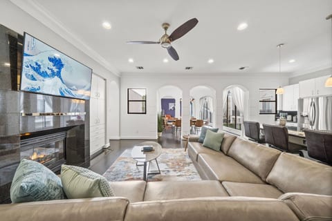 Gather in style w/a luxurious spacious leather sectional, fireplace & 65” TV. Open-concept space seamlessly connects to the dining area w/seating for 8 and kitchen bar w/6 stools. Selection of board games add a fun touch to this welcoming retreat!