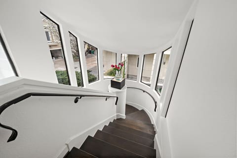 Step into a light-filled front entry that seamlessly flows either through to the backyard and pool oasis or up the rounded staircase. This entire space is bathed in natural light from large windows.