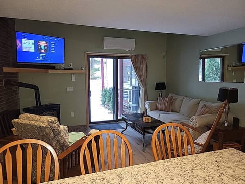 Living Room with ceiling fan, propane stove, mini-split, and smart TV with cable