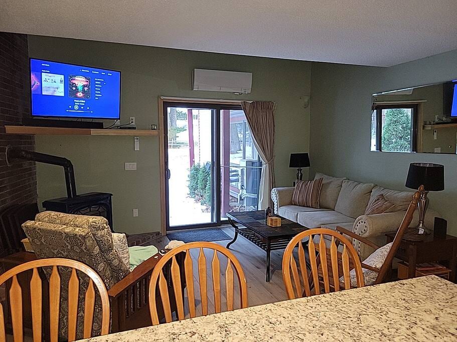 Living Room with ceiling fan, propane stove, mini-split, and smart TV with cable