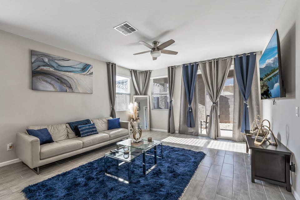 Bright modern living room with stylish decor, TV, and patio access