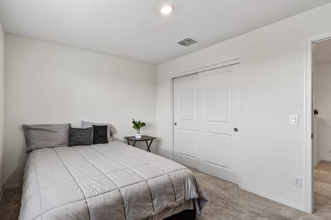 Bright, cozy bedroom with plush carpeting and spacious closet