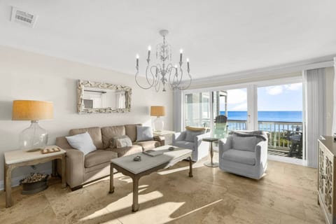 Bright beachfront living room with balcony and sweeping ocean views