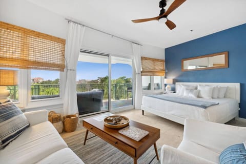 Bright king suite with private balcony, lounge area, and serene views