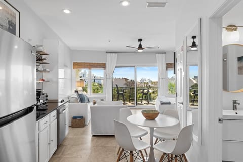 Bright open-concept condo with balcony seating and abundant natural light