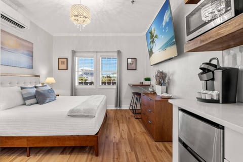 Bright coastal studio with kitchenette, workspace, and comfy bed