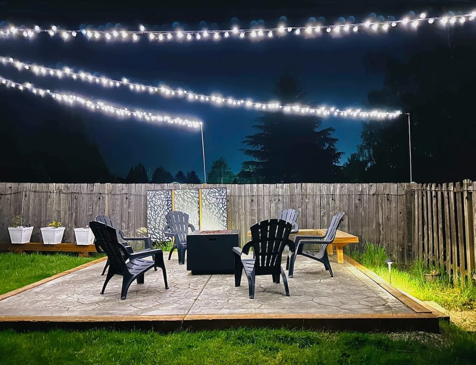 • Enjoy fresh air and starry nights in your private backyard. 
•Cozy up by the firepit, illuminated by gorgeous, automated overhead string lighting that turns on at dusk and casts a warm, magical glow for four hours.